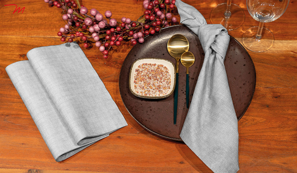 Edle Spanlin-Servietten mit stoffähnlicher Struktur, dekorativ arrangiert für festliche Anlässe und gehobene Tischkultur